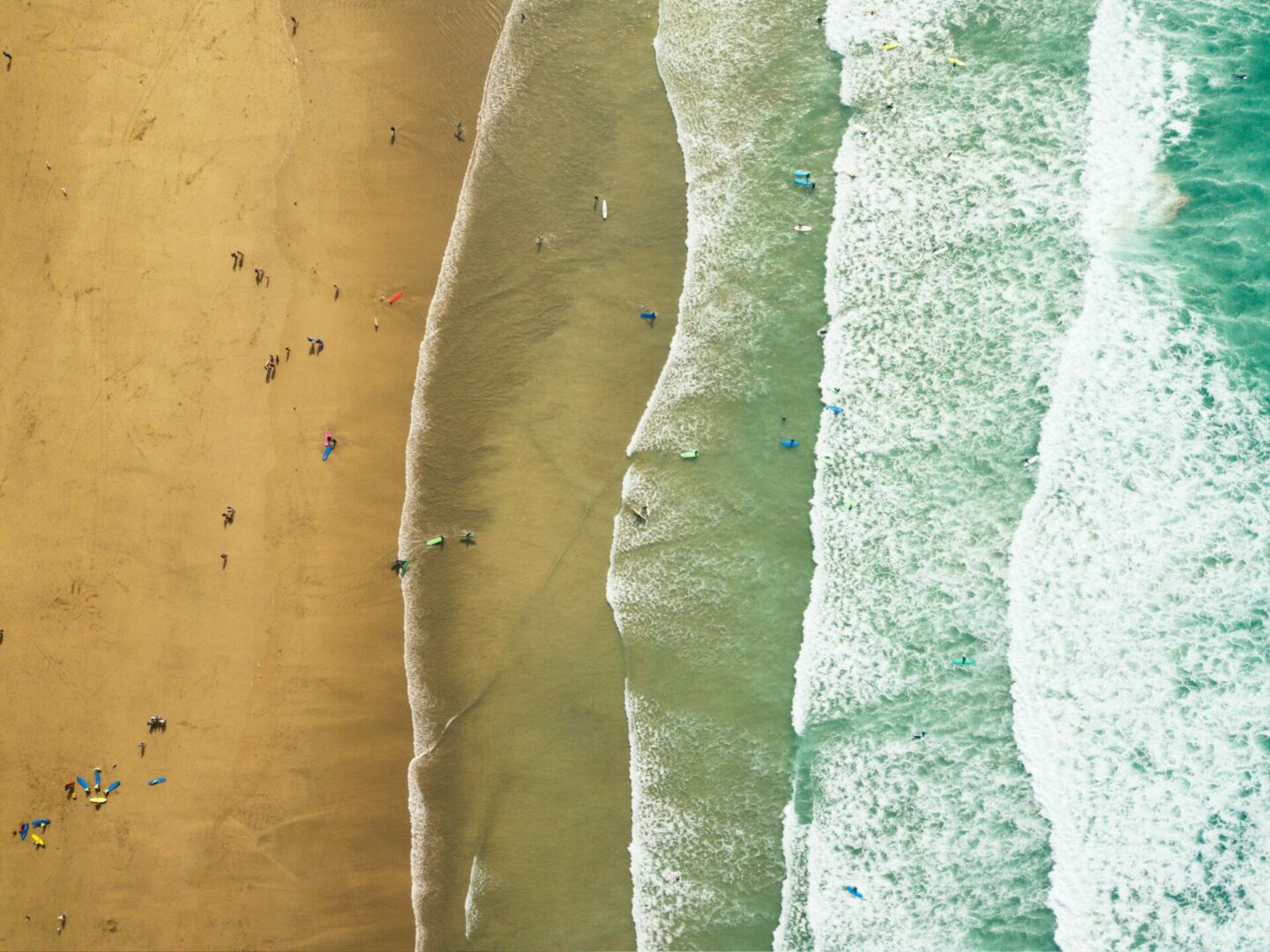 An aerial view of the surf in Cornwall. Waves coming in right to left.